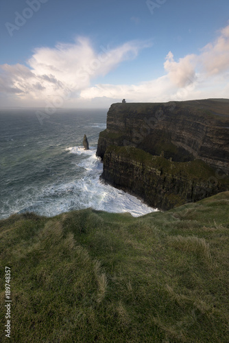 The Cliffs of Moher winds whip around at sunset, Co. Clare, Ireland.