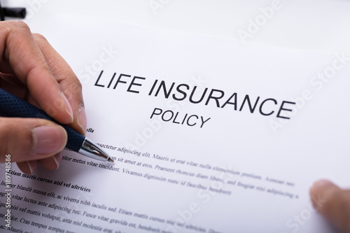 Person Filling Life Insurance Policy Form