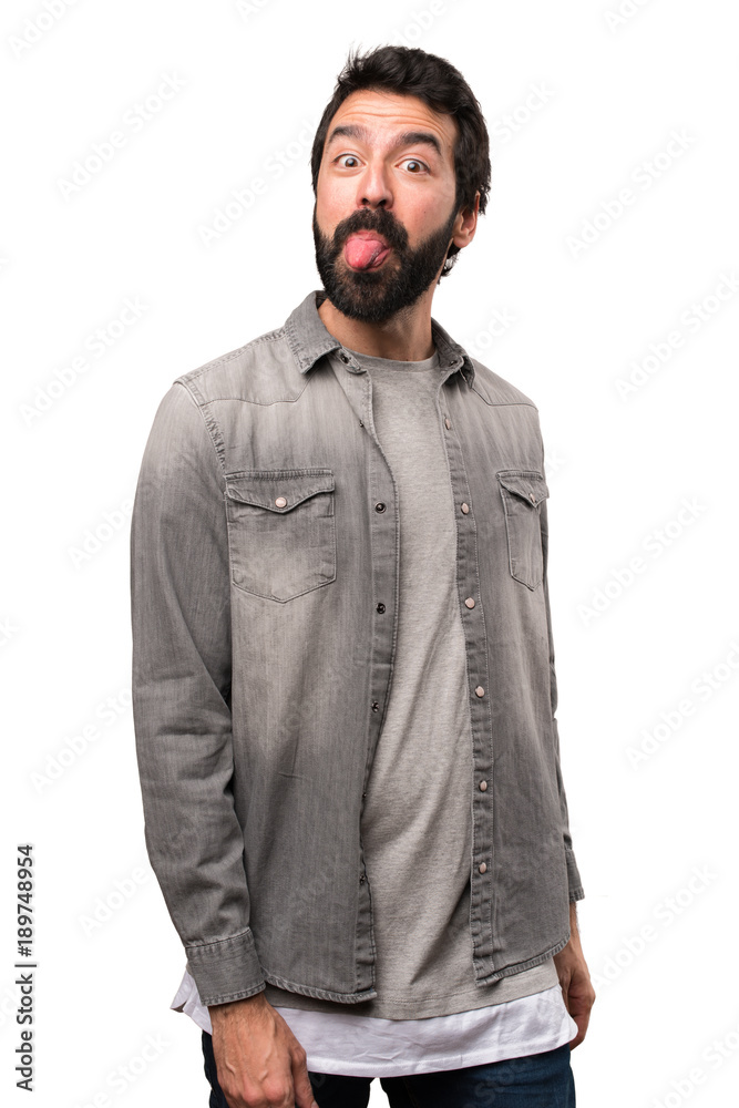 Handsome man with beard taking out his tongue on white background Handsome man with beard taking out his tongue on white background