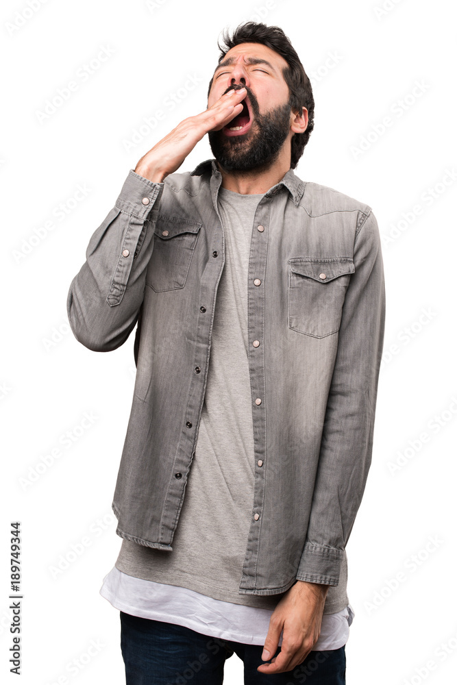 Handsome man with beard yawning on white background Handsome man with beard yawning on white background