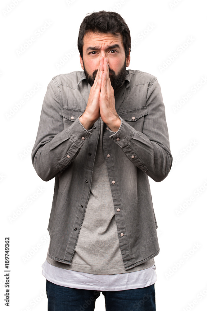 Handsome man with beard pleading on white background Handsome man with beard pleading on white background