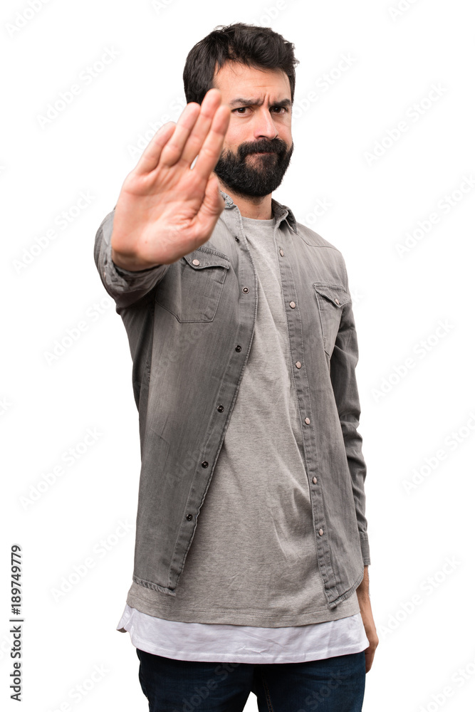 Handsome man with beard making stop sign on white background Handsome man with beard making stop sign on white background