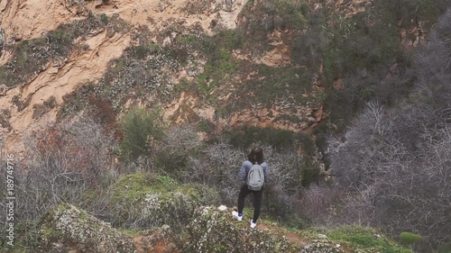 tourists stand on a rock and look at a magnificent mountain landscape and architecture