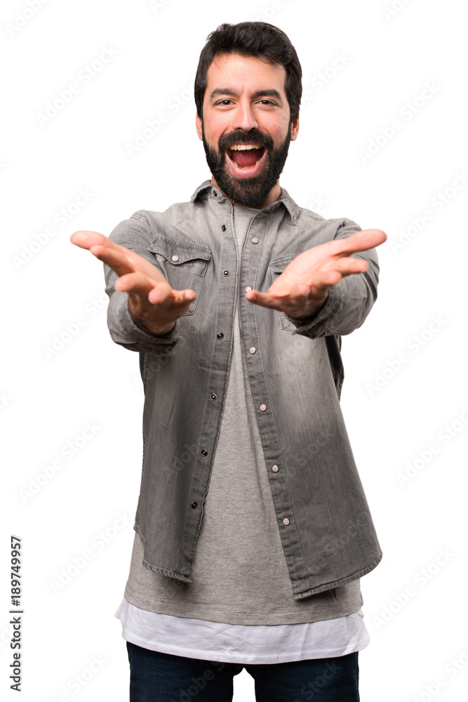 Handsome man with beard presenting something on white background Handsome man with beard presenting something on white background