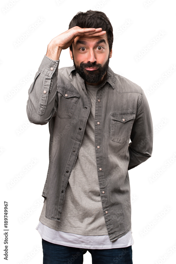Handsome man with beard showing something on white background Handsome man with beard showing something on white background