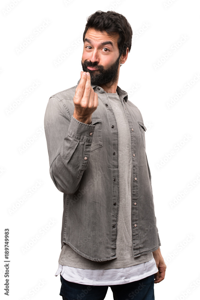 Fototapeta premium Handsome man with beard making money gesture on white background