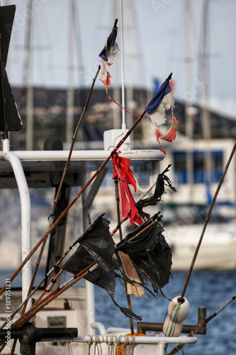 Flags on buoys of a fishing boat in the Port of Cavalaire sur Mer, photo