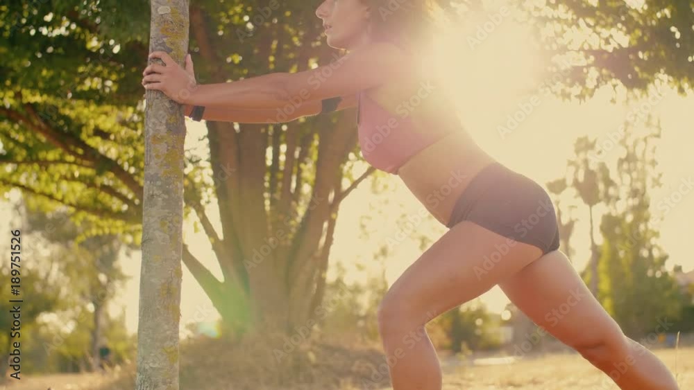 Female jogger stretching in the park