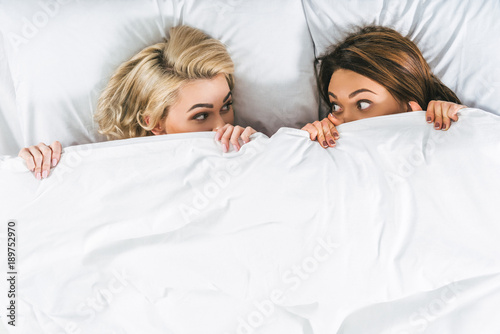 top view of beautiful women relaxing in bed