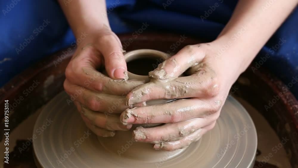 Process of creating a jar or vase of clay. Woman hands on potter's wheel Process of creating a jar or vase of clay. Woman hands on potter's wheel