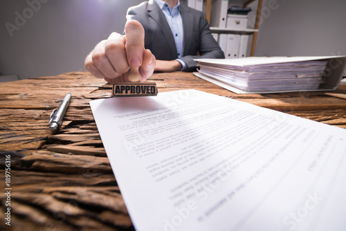 Close-up Of A Businessperson Approving Document