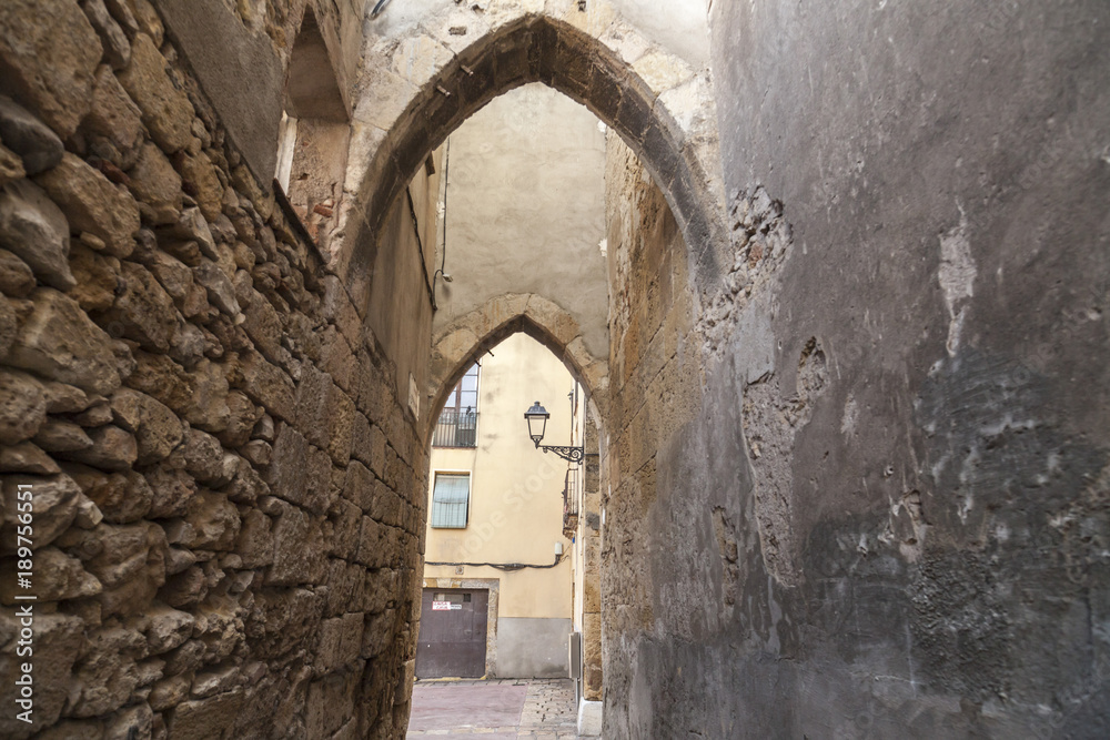 Narrow street in Jewish quarter of Tarragona, Catalonia, Spain.