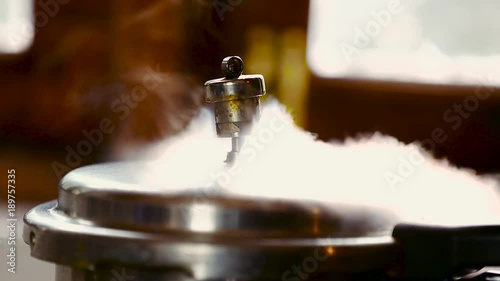 whistling of pressure cooker at house kitchen
