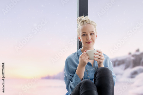woman drinking coffee and using laptop at home