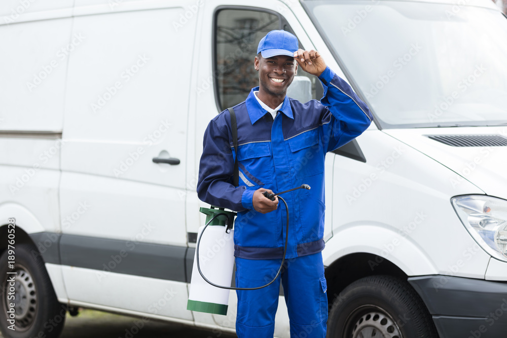 Young Smiling Male Worker With Pesticide Sprayer Young Smiling Male Worker With Pesticide Sprayer