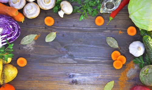 wood background with vegetables, spices and oil