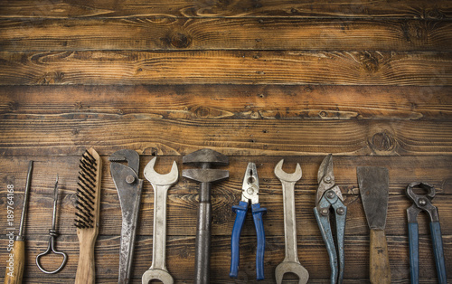 Old different tools on a wooden background with copy space.