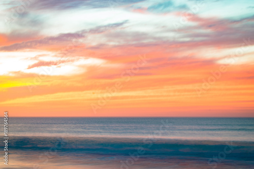 Low speed shutter and evening sunset skies over the sea