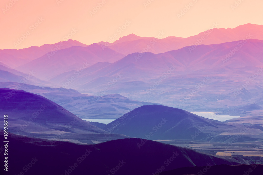 The layered silhouettes of mountains at sunset