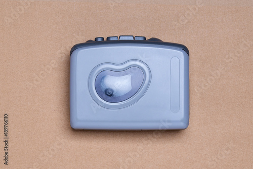 Retro walkman without headphones on the brown background