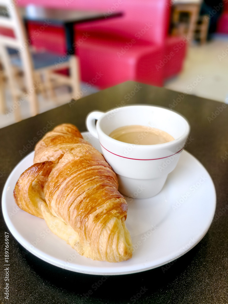 Breakfast with coffee and croissants on table Breakfast with coffee and croissants on table