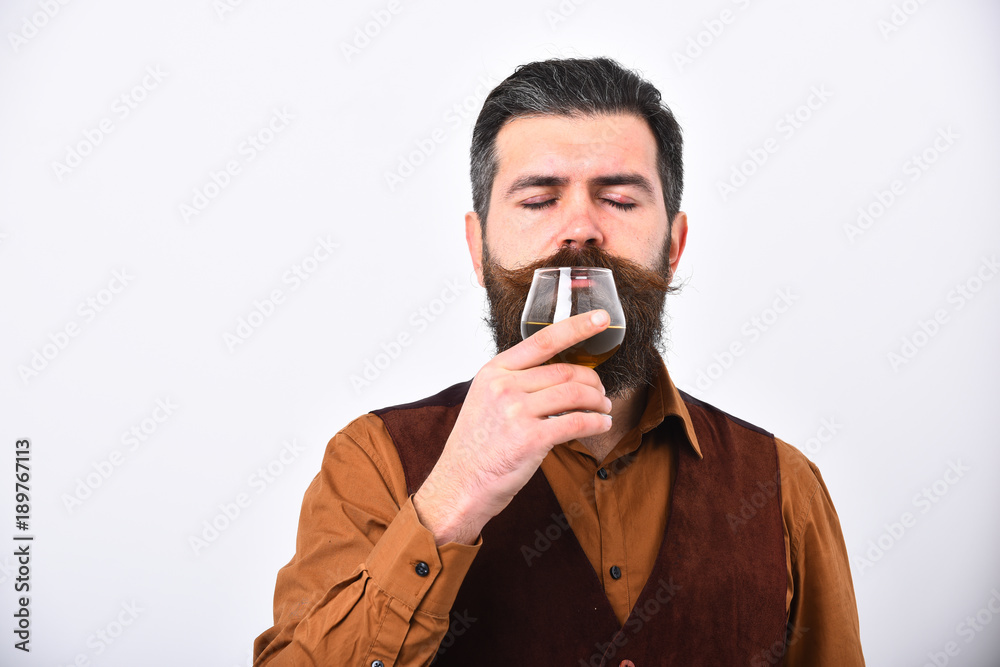 Barman or degustator with dreamy face tastes cognac. Barman or degustator with dreamy face tastes cognac.