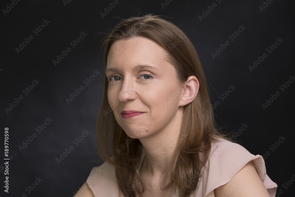 Portrait of a woman with long hair, smiling Portrait of a woman with long hair, smiling