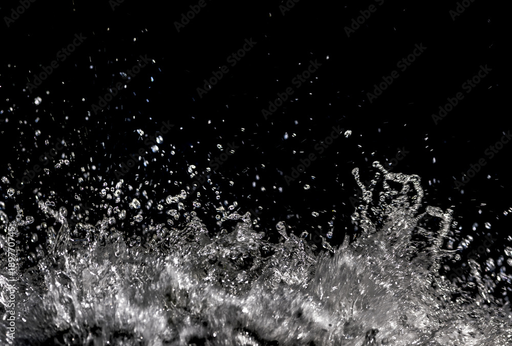 Water splash transparent on black background with copy space, sparkling water drops detail, shot taken in nature, waterfall at Plitvice lakes, Croatia, Europe Water splash transparent on black background with copy space, sparkling water drops detail, shot taken in nature, waterfall at Plitvice lakes, Croatia, Europe