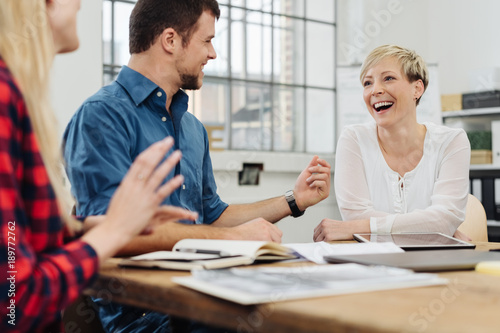 Happy motivated business team enjoying a laugh photo