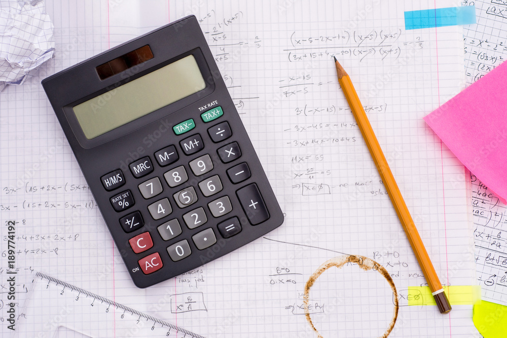Education and Science concept. Handheld Calculator, Pencil, Ruler over Sheet of Paper with Mathematical Formulas. Education and Science concept. Handheld Calculator, Pencil, Ruler over Sheet of Paper with Mathematical Formulas.