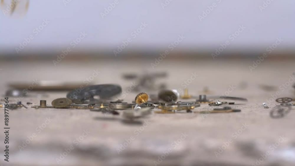 Super slow motion of watch parts falling to the ground Super slow motion of watch parts falling to the ground