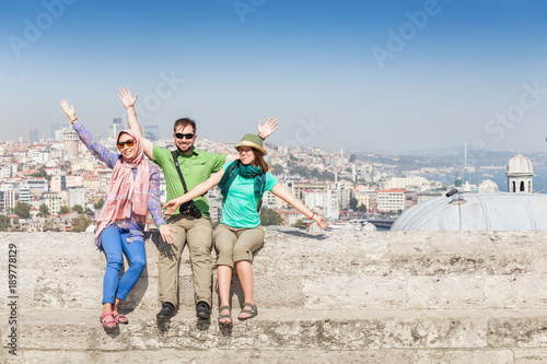Group of Friends hugging and looking at Istanbul great Blue Mosque. Student travel in Turkey concept