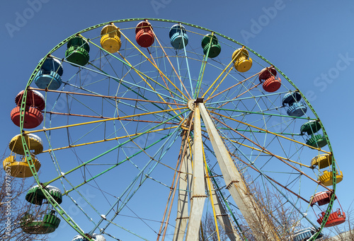 A colourful ferris wheel in winter on sunny day