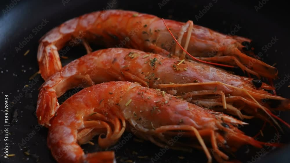 closeup large red shrimps are fried in hot oil on pan closeup large red shrimps are fried in hot oil on pan