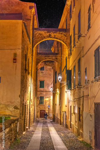 Narrow alley in old town Alghero at night