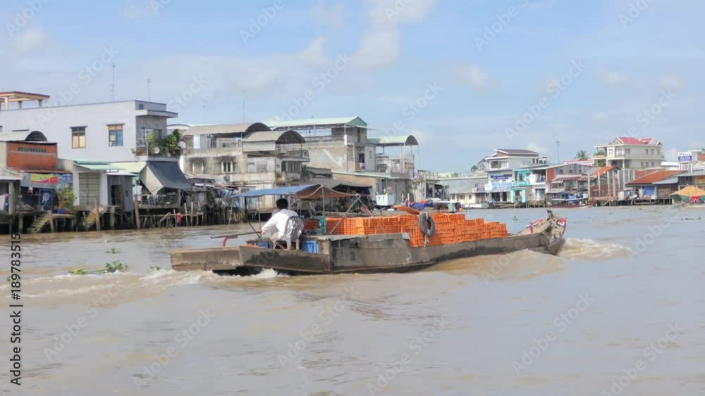 Wooden boat transporting bricks, Mekong River, Vietnam in 4k