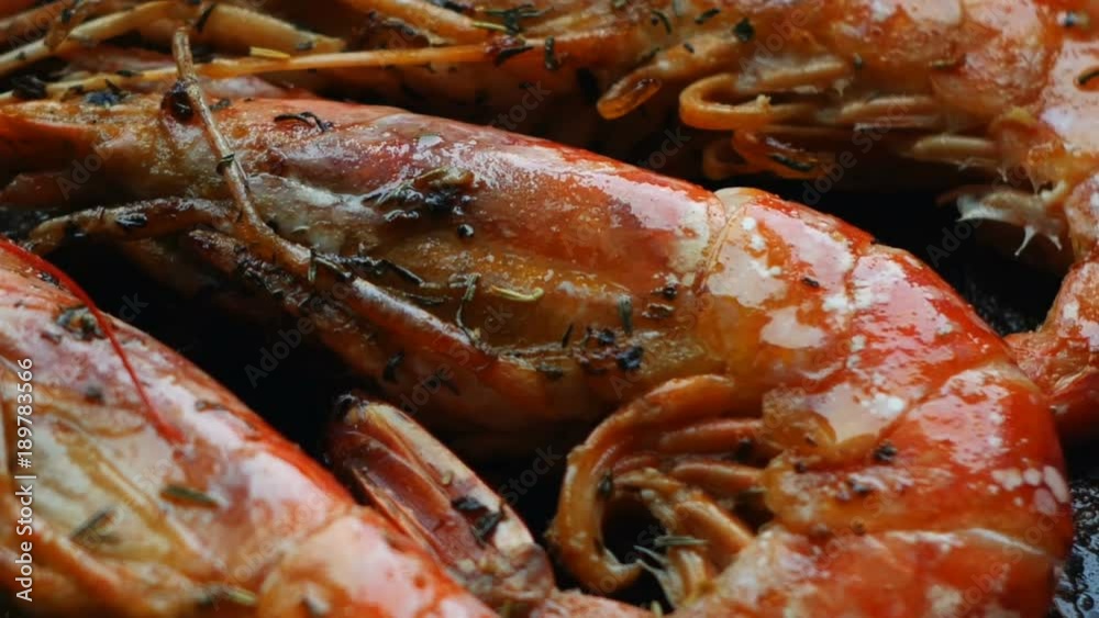 closeup large red shrimps are fried in hot oil on pan closeup large red shrimps are fried in hot oil on pan