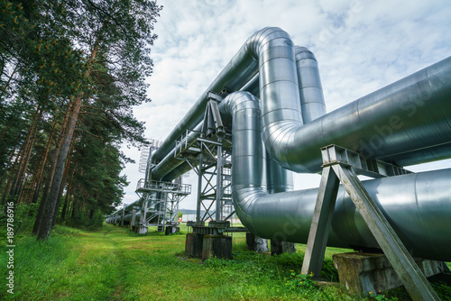 Industrial pipelines on pipe-bridge against blue sky