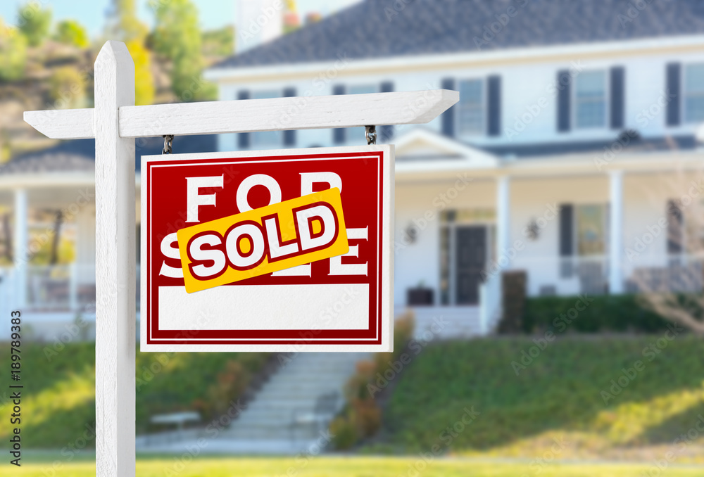 Right Facing Sold For Sale Real Estate Sign In Front of House. Right Facing Sold For Sale Real Estate Sign In Front of House.