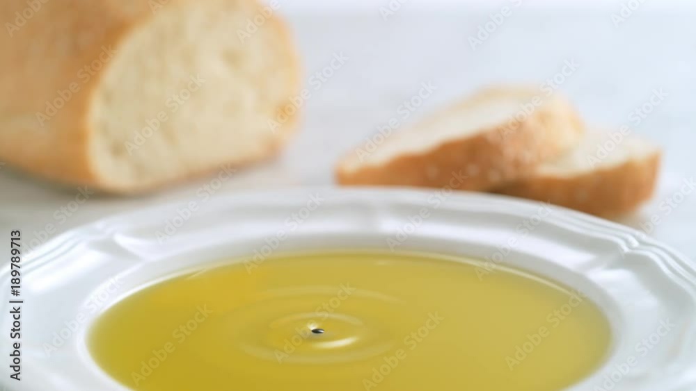 Balsamic vinegar dripping into olive oil. Shot with high speed camera, phantom flex 4K. Slow Motion. Balsamic vinegar dripping into olive oil. Shot with high speed camera, phantom flex 4K. Slow Motion.