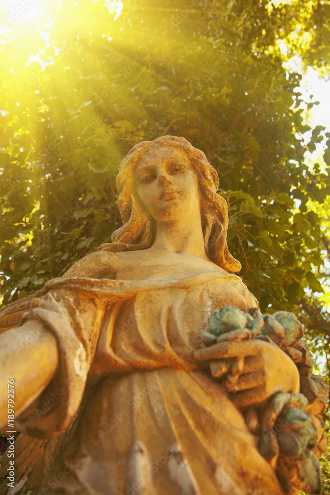 Antique statue of gold angel in the sunlight. (religion, faith, death, resurrection, eternity concept) Antique statue of gold angel in the sunlight. (religion, faith, death, resurrection, eternity concept)