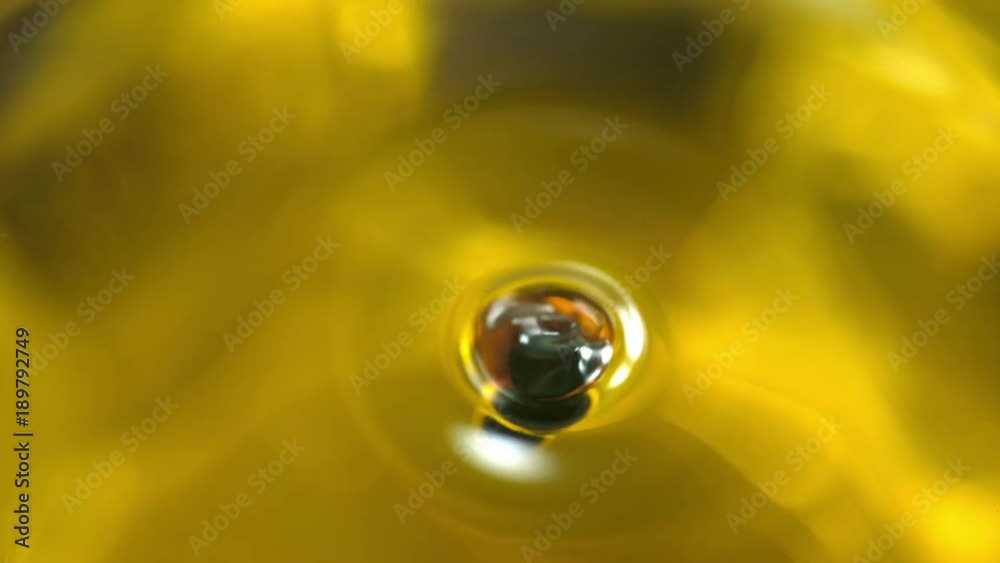 Balsamic vinegar dripping into olive oil. Shot with high speed camera, phantom flex 4K. Slow Motion. Balsamic vinegar dripping into olive oil. Shot with high speed camera, phantom flex 4K. Slow Motion.