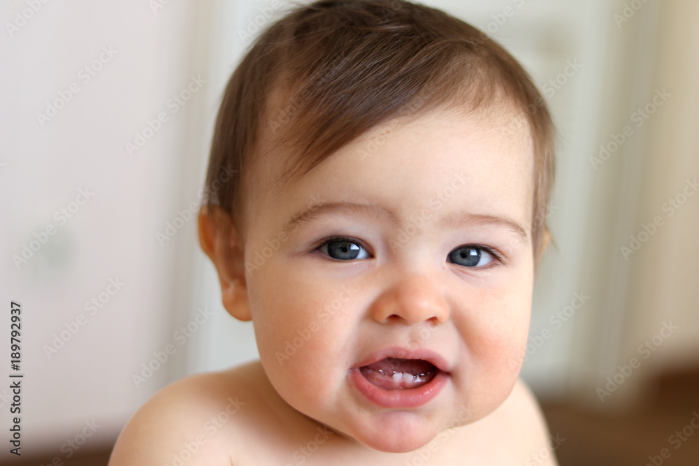 Little baby boy smiling with his first teeth, close-up Little baby boy smiling with his first teeth, close-up