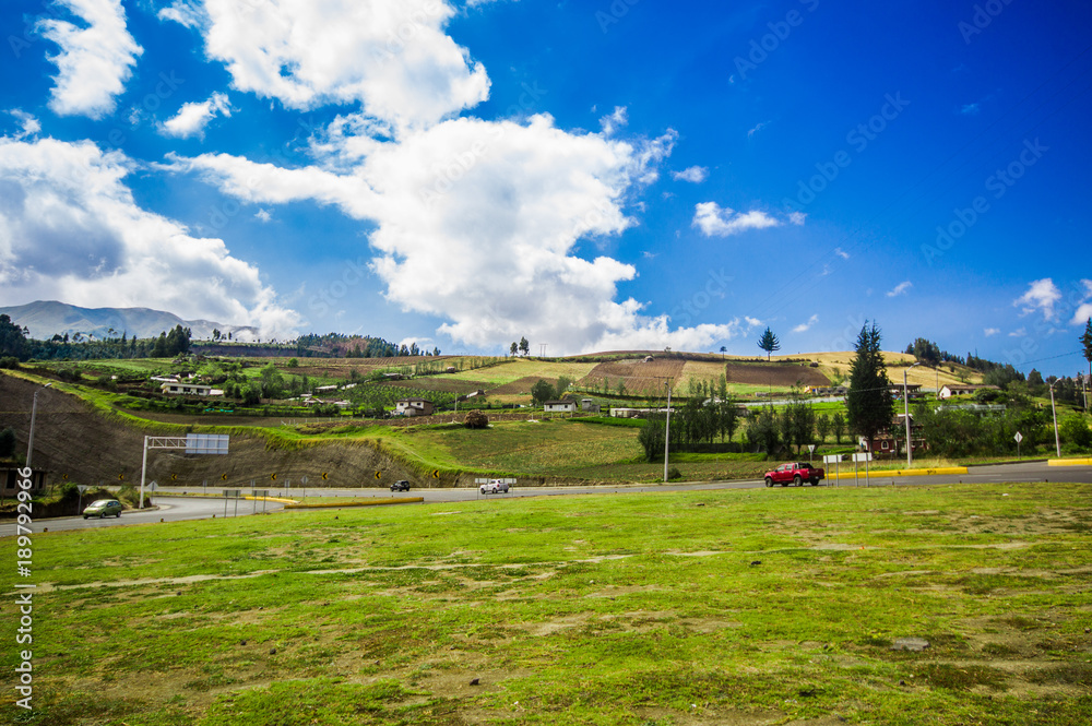 Outdoor view of a rural road on the outskirts of Otavalo, in a beautiful blue sky with some green grass