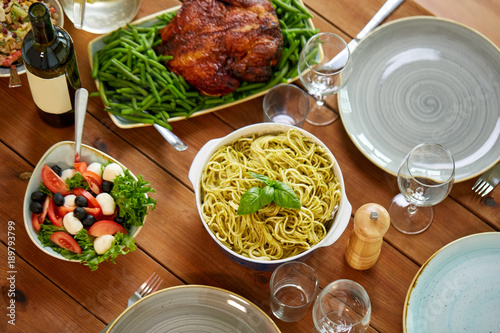 pasta, vegetable salad and other food on table