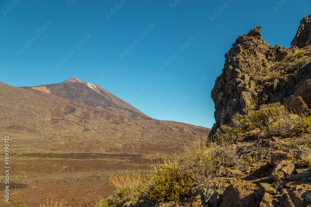 Fototapeta premium Teide National Park, Tenerife, Canary Islands - A picturesque view of the colourful Teide volcano, or in spanish 'Pico del Teide'. The tallest peak in Spain with an elevation of 3718 m