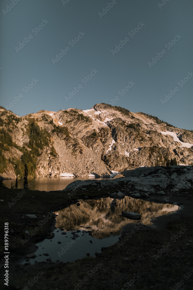 reflecting mountain with snow in sunset