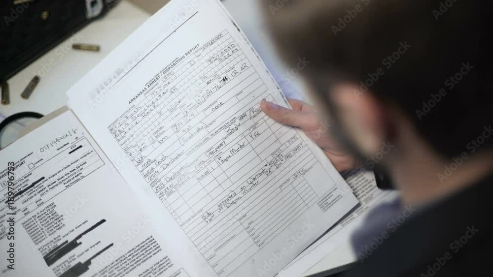 Detective checking arrest report, offense incident summary, confidential memo