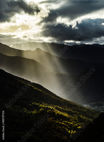 Sun rays lighting through the clouds in high Pyrenees