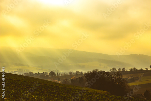 Beautiful scenic sunrise with scattered clouds over hilly rural landscape in Lower Austria